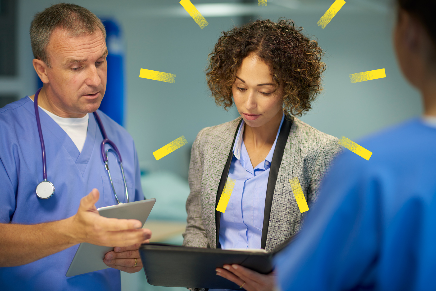 Medical professionals looking at a tablet device